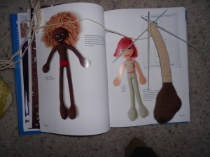 She's doing the red-headed doll on the right. The leg is right beside the photo.