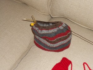 Little hat with one mitten in the corner.